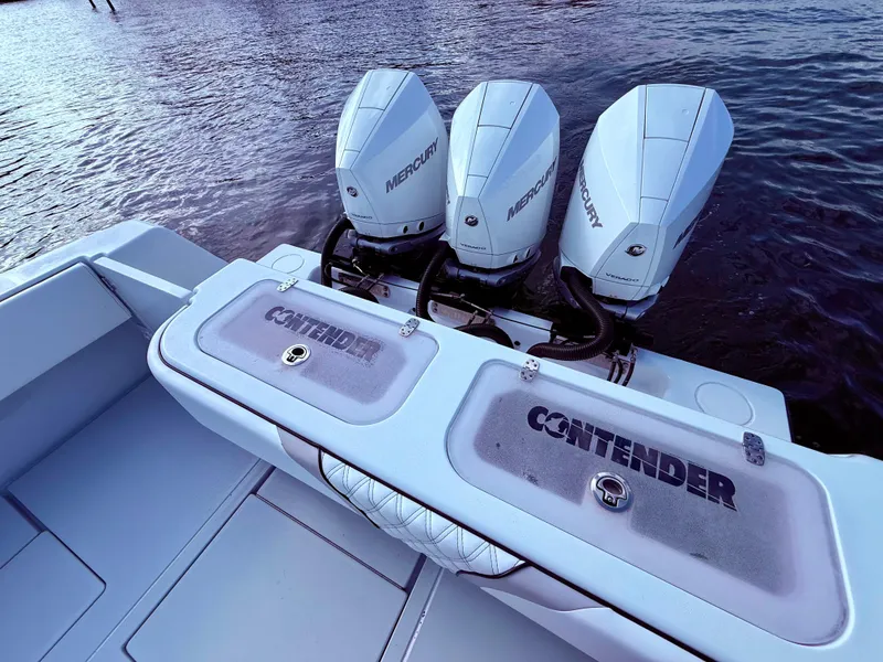 Slide: The Image of 2024 Contender 39 ST boat with triple Mercury outboard engines on water. - 19