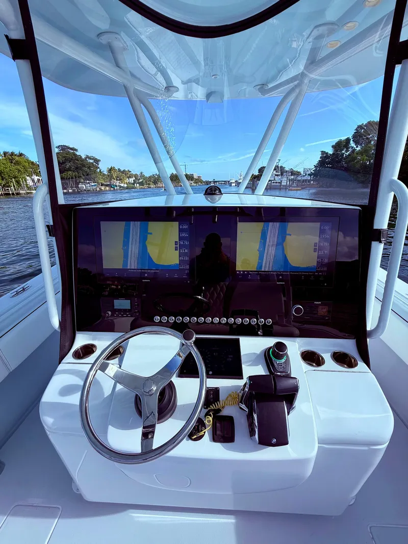 Slide: The Image of 2024 Contender 39 ST boat helm with advanced navigation system and steering wheel. - 23