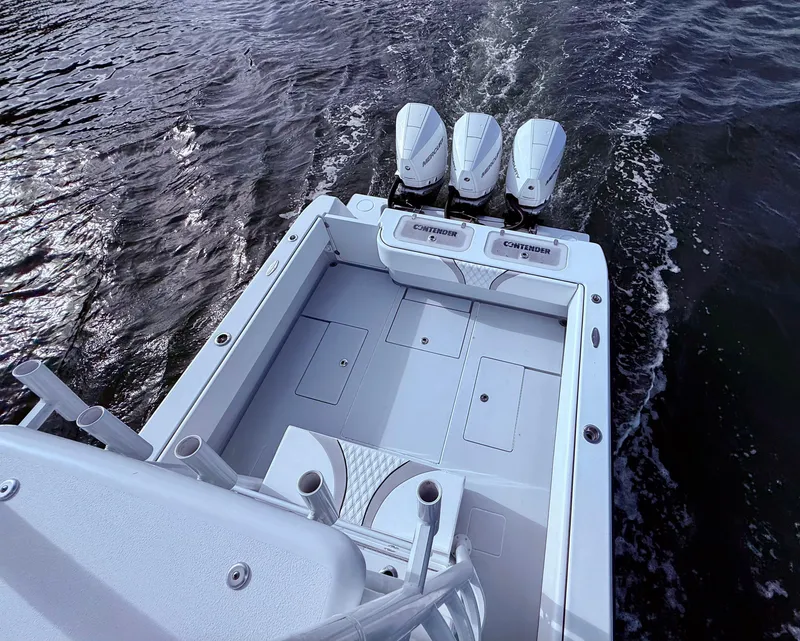Slide: The Image of 2024 Contender 39 ST boat with triple engines on water. - 30