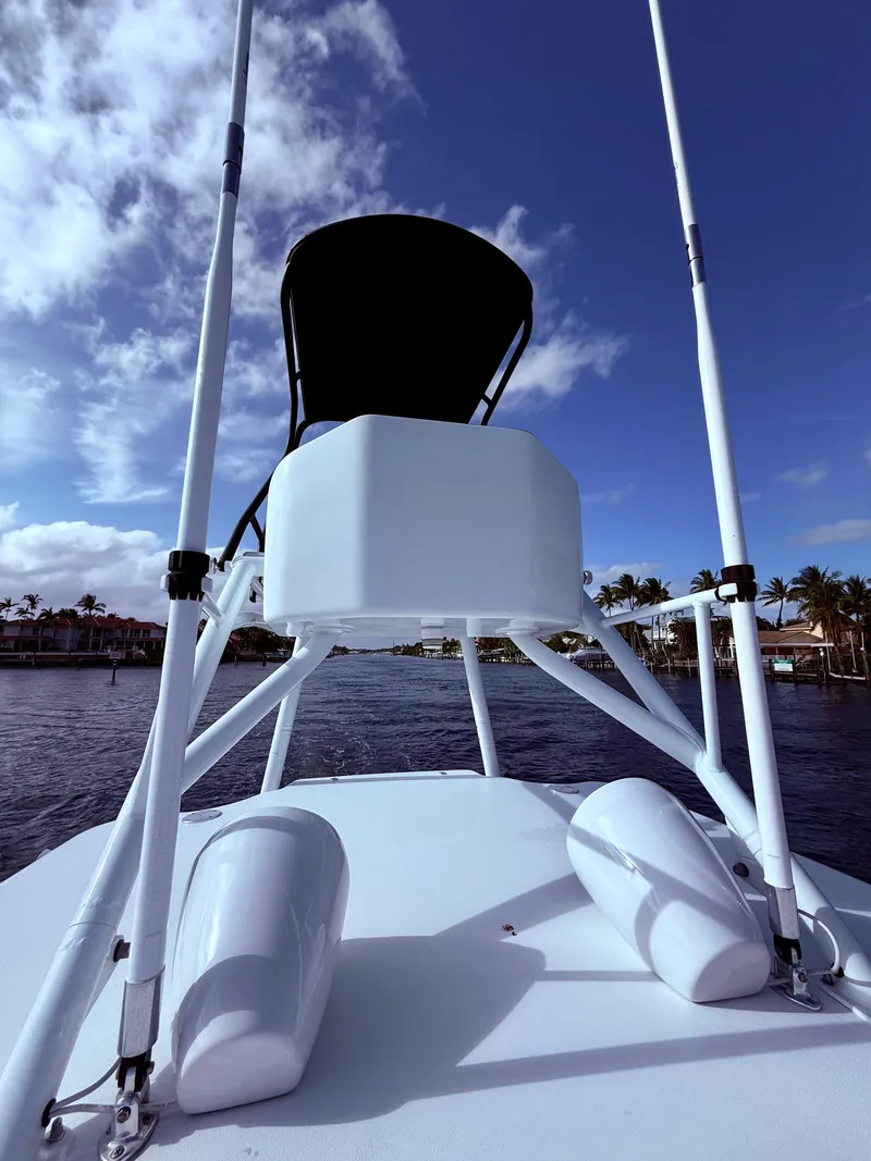 Slide: The Image of 2024 Contender 39 ST boat with tower against a blue sky and waterfront view. - 32