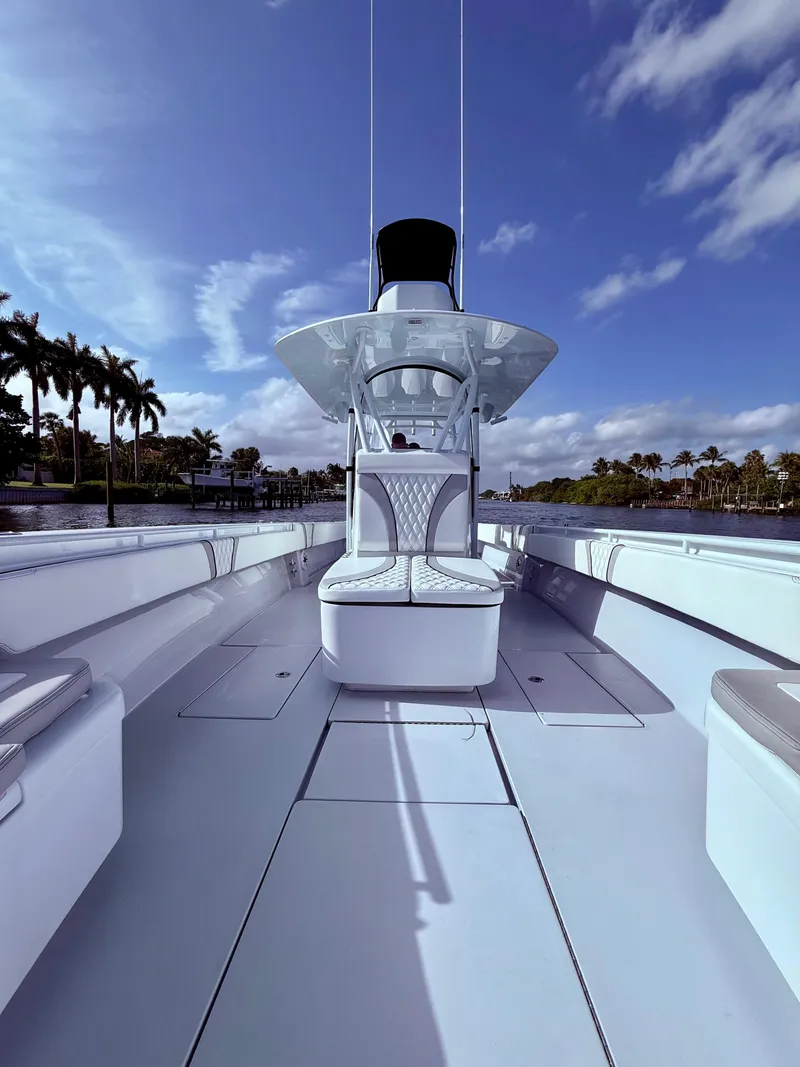 Slide: The Image of 2024 Contender 39 ST boat with sleek design, spacious deck, and modern features under a clear sky. - 6
