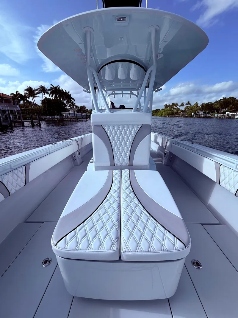 Slide: The Image of 2024 Contender 39 ST boat interior with luxurious seating and sleek design on a sunny day. - 8