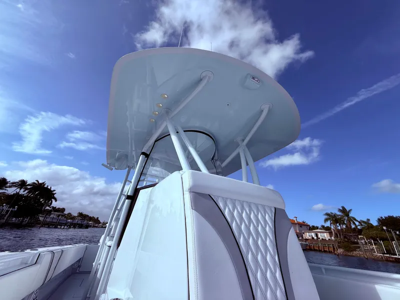 Slide: The Image of 2024 Contender 39 ST boat with sleek design under a clear blue sky. - 9