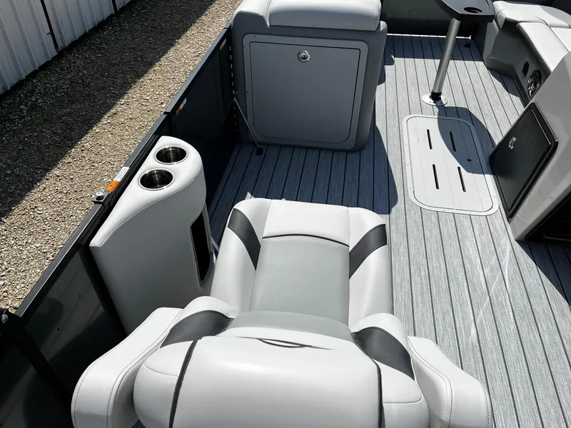 Slide: The Image of 2025 SunCatcher Select 322RC boat interior with gray seating and flooring. - 10