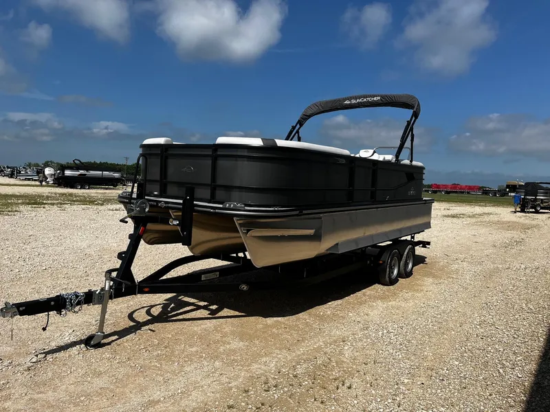 Slide: The Image of 2025 SunCatcher Select 322RC pontoon boat on trailer under a clear blue sky. - 3