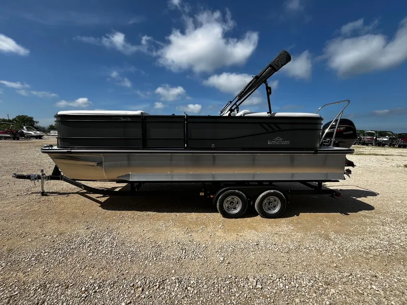 Slide: The Image of 2025 SunCatcher Select 322RC pontoon boat on trailer under blue sky. - 4