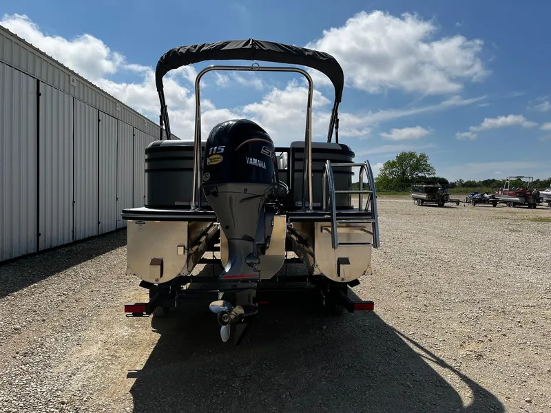 Slide: The Image of 2025 SunCatcher Select 322RC pontoon boat with Yamaha motor, parked outdoors. - 6