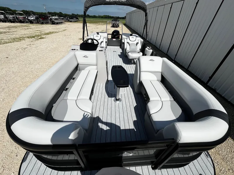 Slide: The Image of 2025 SunCatcher Select 322RC pontoon boat with spacious seating and modern design. - 8