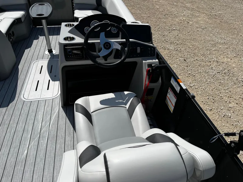Slide: The Image of 2025 SunCatcher Select 322RC boat interior with steering wheel and seating. - 9