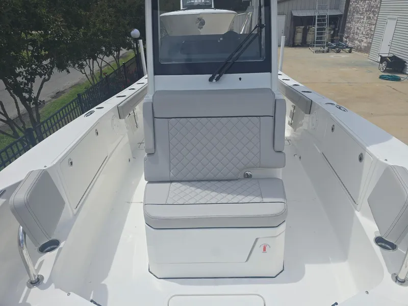 Slide: The Image of 2025 Pursuit S 248 Sport boat interior with cushioned seating and sleek design. - 10