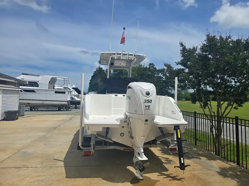 Slide: The Image of 2025 Pursuit S 248 Sport boat with 350 HP engine on trailer, sunny day. - 3