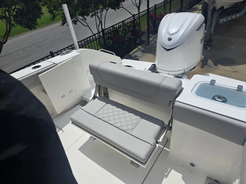 Slide: The Image of 2025 Pursuit S 248 Sport boat interior with seating and motor, showcasing modern design. - 4