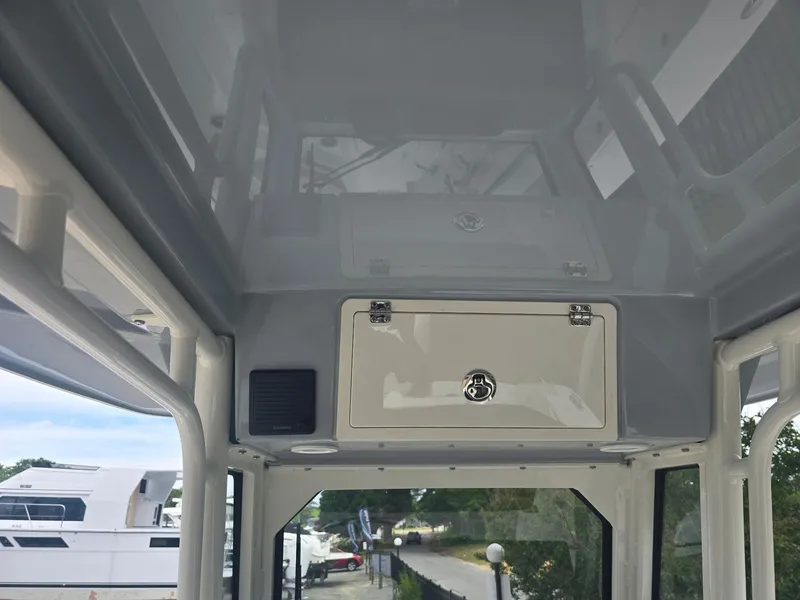 Slide: The Image of 2025 Pursuit S 248 Sport boat interior with storage compartment and sleek design. - 6