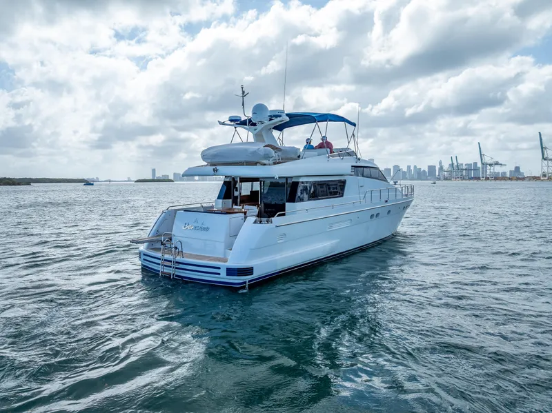 Slide: The Image of Sanlorenzo 62 yacht from 1995 cruising on open water under a cloudy sky. - 11