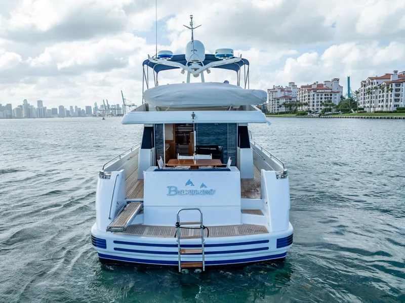 Slide: The Image of Sanlorenzo 62 yacht from 1995 on water, city skyline in background. - 12