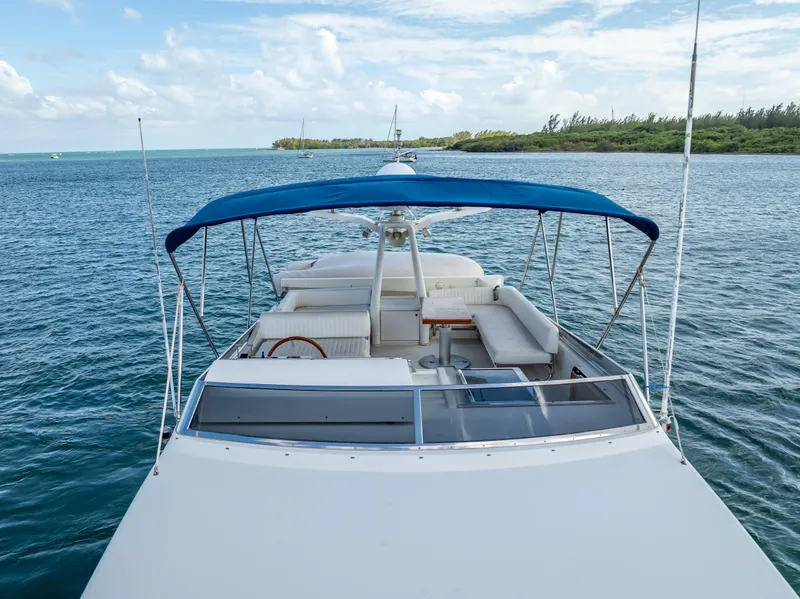 Slide: The Image of Sanlorenzo 62 yacht, 1995 model, with blue canopy, cruising on open water. - 17