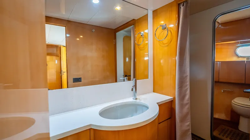 Slide: The Image of Luxurious bathroom in 1995 Sanlorenzo 62 yacht with modern fixtures and wood paneling. - 23