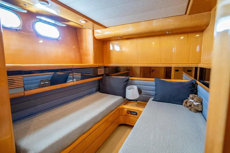 Slide: The Image of Luxurious cabin interior of 1995 Sanlorenzo 62 yacht with cozy seating and elegant wood finish. - 25