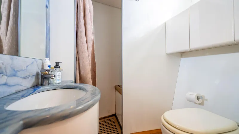 Slide: The Image of Bathroom interior of a 1995 Sanlorenzo 62 yacht with marble countertop and shower. - 27