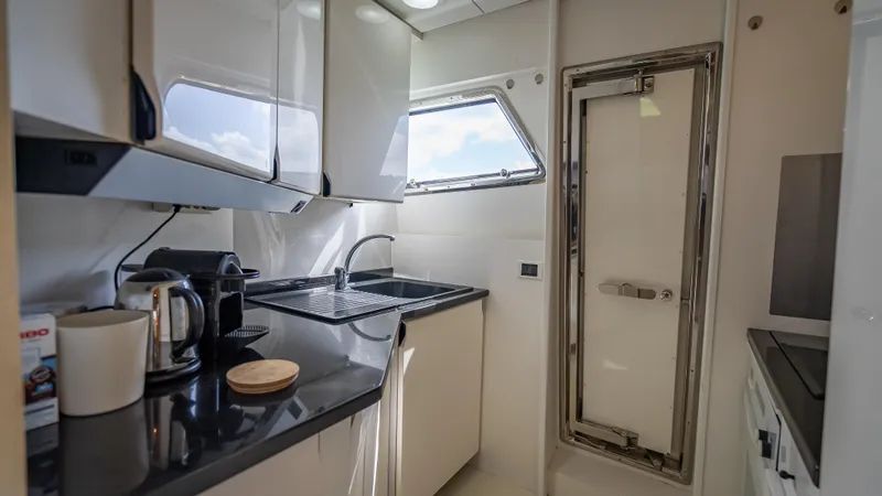 Slide: The Image of Compact kitchen in a 1995 Sanlorenzo 62 yacht with modern appliances and sleek design. - 30