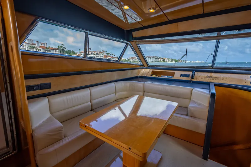 Slide: The Image of Luxurious interior of 1995 Sanlorenzo 62 yacht with leather seating and wooden table. - 33