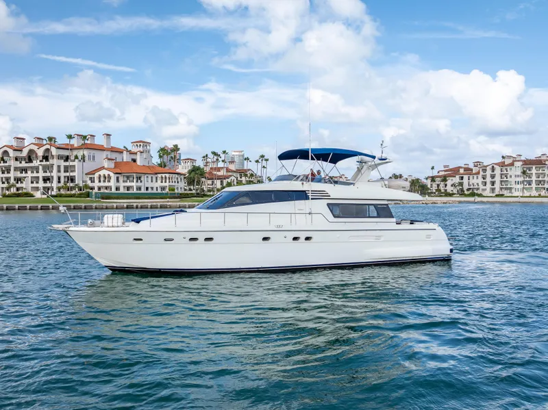 Slide: The Image of Sanlorenzo 62 yacht from 1995 cruising near luxury waterfront homes. - 4