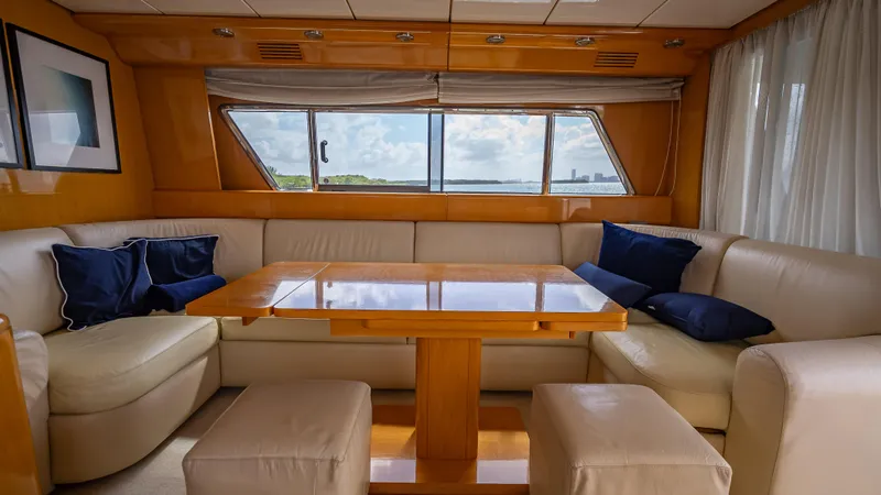 Slide: The Image of Luxurious Sanlorenzo 62 yacht interior, featuring elegant seating and a wooden table, 1995 model. - 44