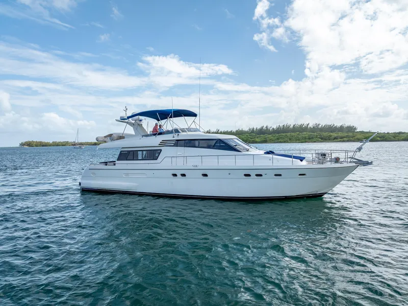 Slide: The Image of Sanlorenzo 62 yacht from 1995 on calm waters under a blue sky. - 7