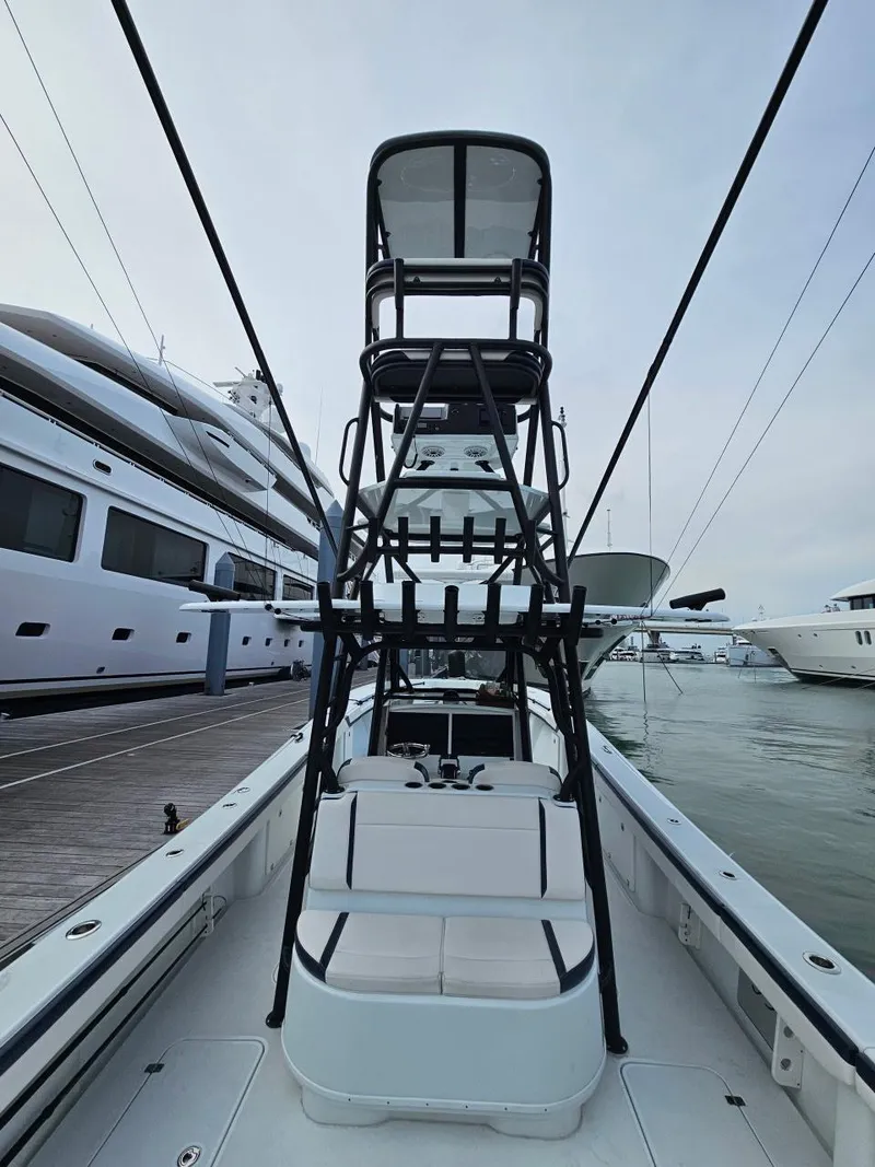Slide: The Image of 2022 Yellowfin 39 Offshore boat with tower, docked alongside luxury yachts. - 3