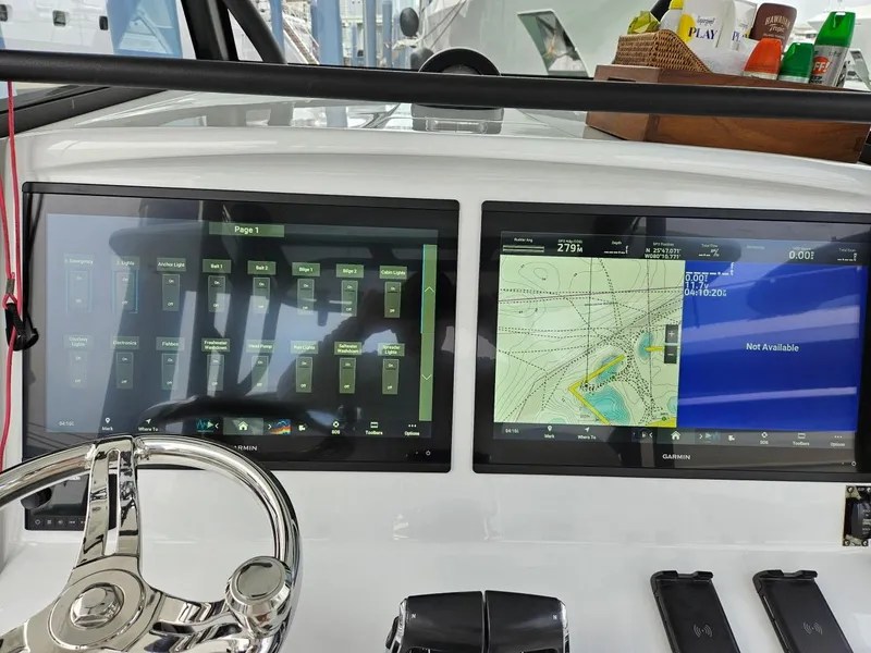 Slide: The Image of 2022 Yellowfin 39 Offshore boat dashboard with dual Garmin displays and navigation controls. - 4