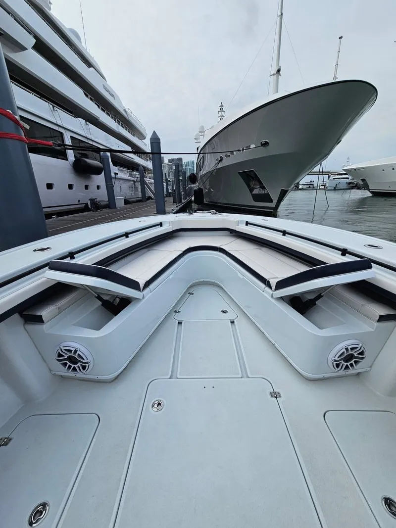 Slide: The Image of 2022 Yellowfin 39 Offshore boat docked at marina, showcasing spacious deck and sleek design. - 6