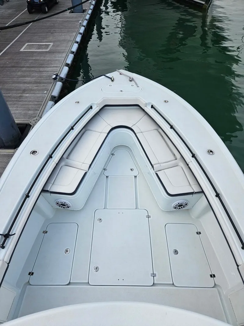 Slide: The Image of 2022 Yellowfin 39 Offshore boat docked, showcasing spacious deck and seating area. - 8