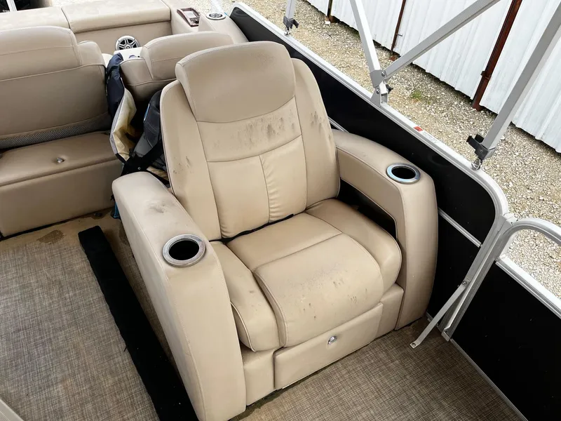 Slide: The Image of Beige recliner seat on 2016 SunCatcher Elite 324 RS boat, featuring cup holders. - 10