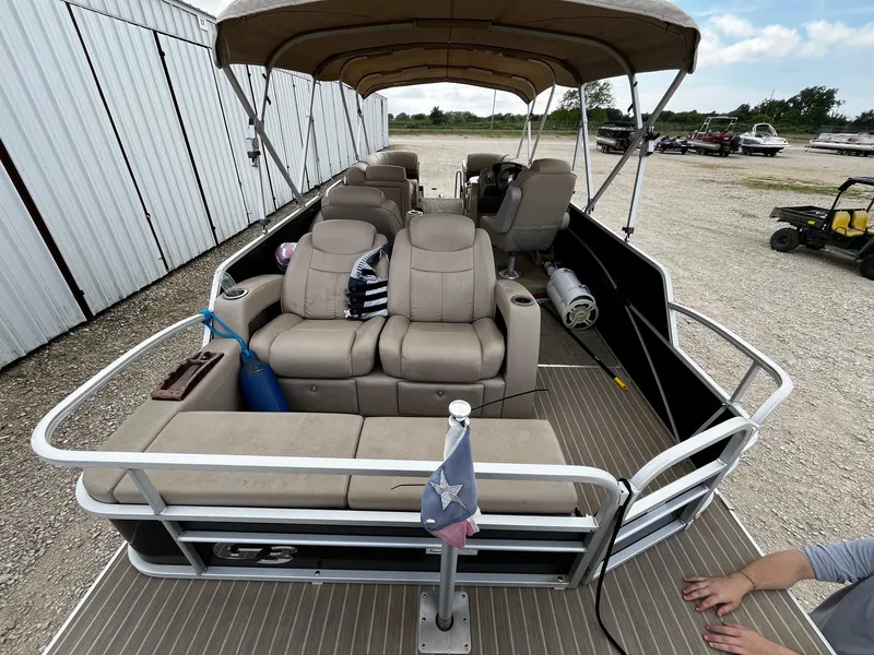 Slide: The Image of 2016 SunCatcher Elite 324 RS pontoon boat with beige seating and canopy, parked outdoors. - 11