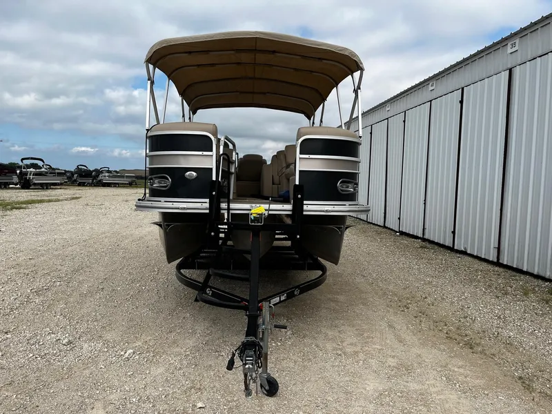 Slide: The Image of 2016 SunCatcher Elite 324 RS pontoon boat on trailer, parked outdoors. - 2