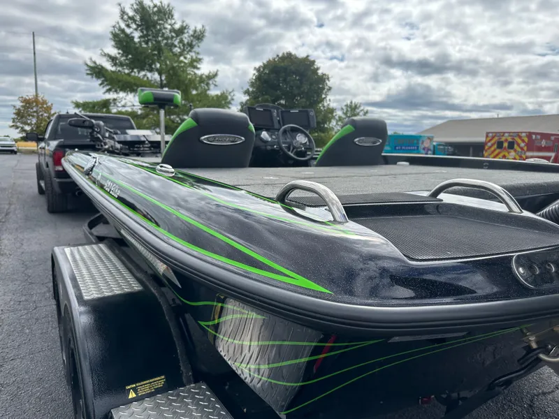 Slide: The Image of 2021 Phoenix 920 Elite boat on trailer, featuring sleek black and green design. - 10