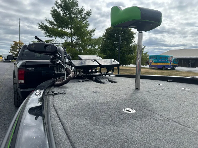 Slide: The Image of 2021 Phoenix 920 Elite boat with advanced electronics, parked near a truck under cloudy skies. - 13