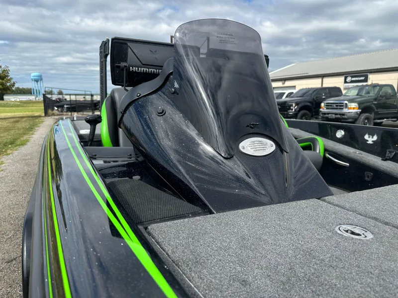 Slide: The Image of 2021 Phoenix 920 Elite boat with sleek design and green accents, parked outdoors. - 17