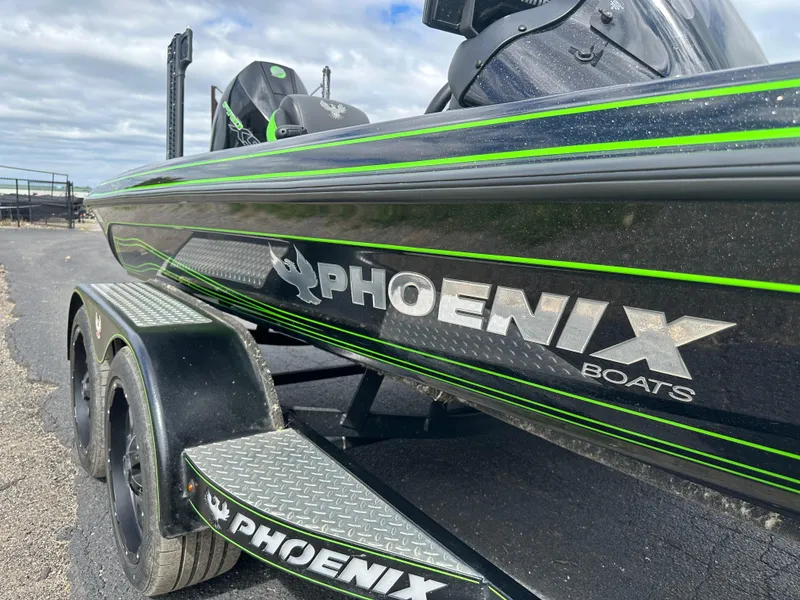 Slide: The Image of 2021 Phoenix 920 Elite boat with green accents on a trailer. - 18