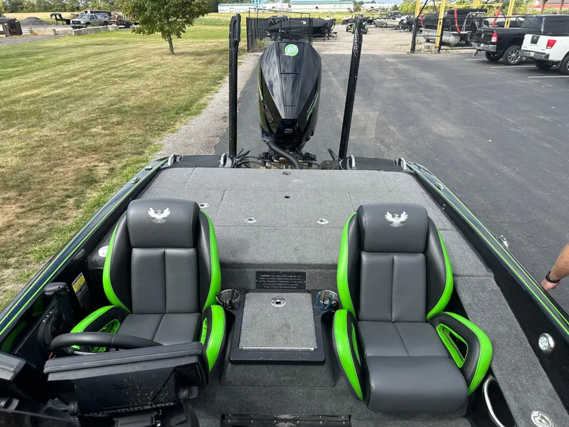 Slide: The Image of 2021 Phoenix 920 Elite boat interior with green-accented seats and control panel. - 19