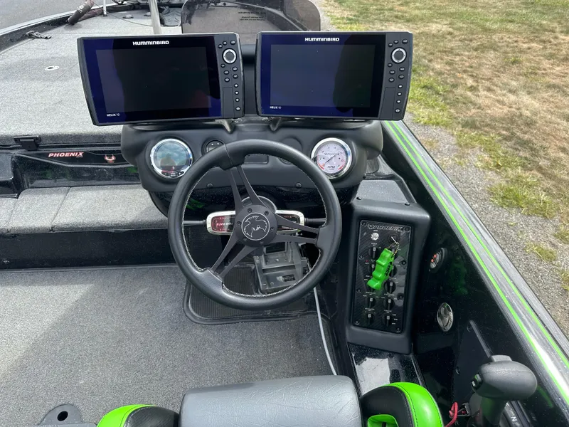Slide: The Image of 2021 Phoenix 920 Elite boat dashboard with dual Humminbird displays and steering wheel. - 20