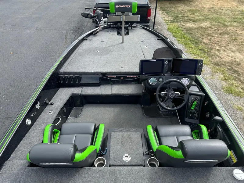 Slide: The Image of 2021 Phoenix 920 Elite boat interior with dual seats, steering wheel, and navigation screens. - 21