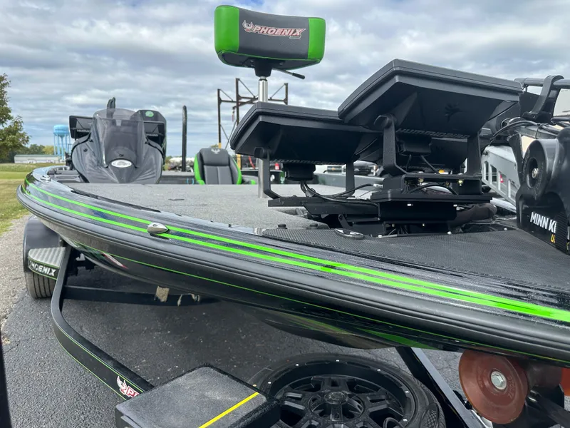 Slide: The Image of 2021 Phoenix 920 Elite boat with advanced equipment, green accents, and overcast sky background. - 4