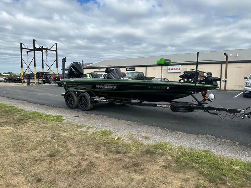Slide: The Image of 2021 Phoenix 920 Elite boat on trailer, parked outdoors near a building under cloudy skies. - 5