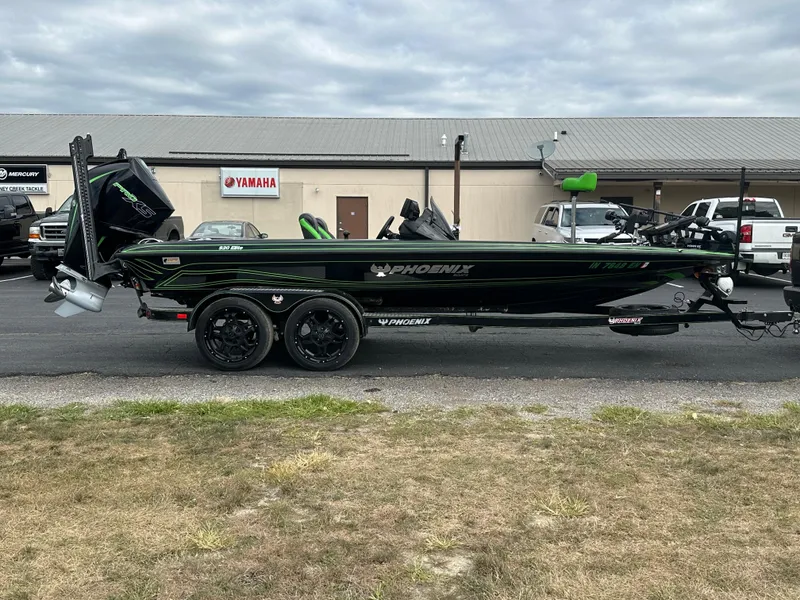Slide: The Image of 2021 Phoenix 920 Elite boat on trailer, parked outside dealership, overcast sky. - 6