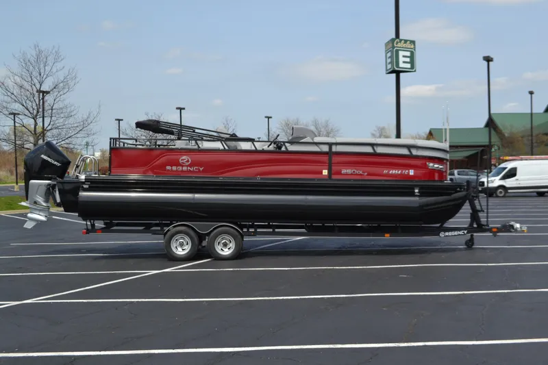 Slide: The Image of 2022 Regency 250DL3 pontoon boat on trailer in parking lot. - 0
