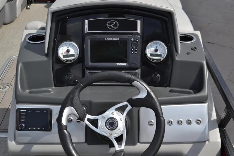Slide: The Image of 2022 Regency 250DL3 boat dashboard with steering wheel and navigation controls. - 1