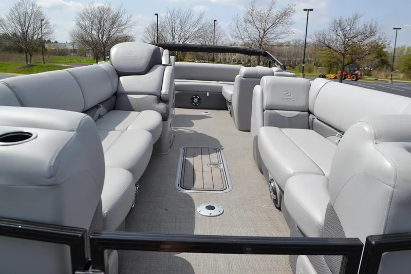 Slide: The Image of 2022 Regency 250DL3 pontoon boat interior with plush gray seating and spacious layout. - 3