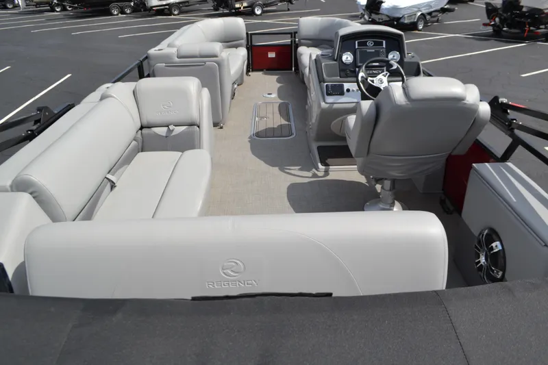 Slide: The Image of 2022 Regency 250DL3 pontoon boat interior with plush seating and modern dashboard. - 5