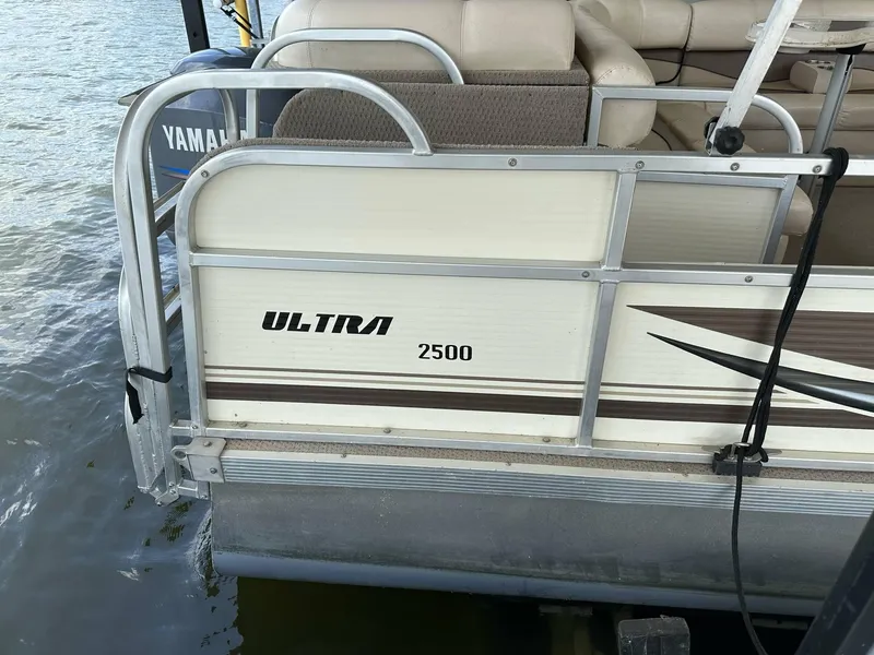 Slide: The Image of 2004 PlayCraft 2500 Ultra pontoon boat docked on water. - 10